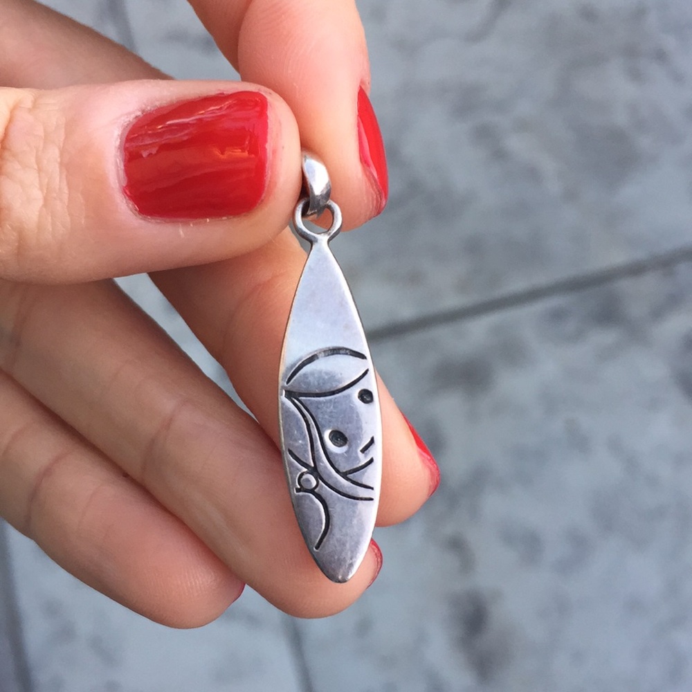 Silver pendant surfboard